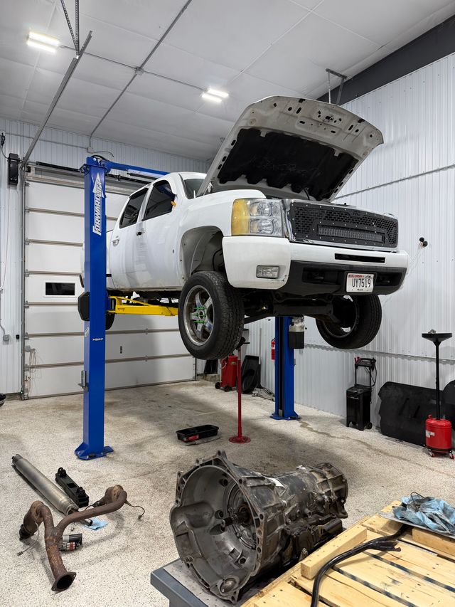 mechanic performing automotive maintenance on car engine